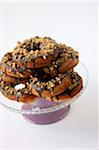 Donuts coated with chocolate and pistachios