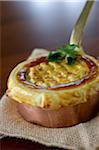 Beef stew cooked in a copper casserole dish and sealed with pastry