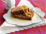 Slices of chocolate cake with custard and orange zests