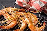 Big shrimps with citronella cooked on a barbecue