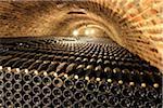 Rows of wine bottles in a cellar