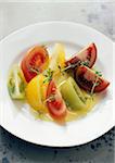Three coloured tomato salad with olive oil and thyme
