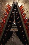 Racks of pink Champagne bottles in a cellar