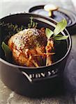 Pigeon cooked in a casserole dish with herbs