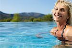 Mature woman relaxing in pool, portrait