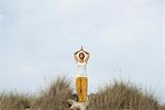 Mature woman doing sun salutation yoga pose