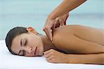Young woman receiving shoulder massage