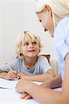 Mother helping son with homework