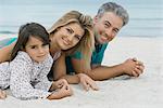 Family lying on beach, portrait