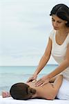 Massage therapist giving woman massage