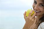 Woman eating apple, portrait