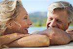 Mature couple relaxing together in pool