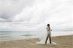 Man wrapped in plastic on beach