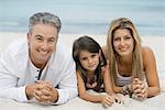 Family lying on beach, portrait