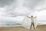 Man with arms outstretched trapped in plastic