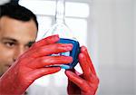 Chemist holding a volumetric flask with a blue liquid