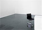 Office chair and desk in an empty room