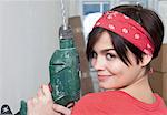 Young woman holding electric drill