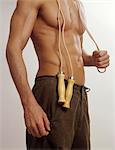 Barechested man with skip rope