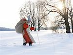 Saint Nicholas walking through winter landscape