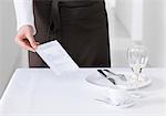 Waitress bringing bill to table