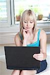 Woman using laptop at home, Munich, Bavaria, Germany