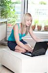 Woman using laptop at home, Munich, Bavaria, Germany