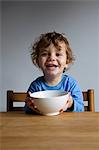 Happy little boy with a bowl