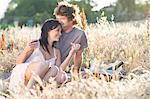 Couple picnicking in wheatfield