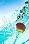 Apple floating in swimming pool