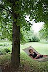 Woman relaxing in hammock