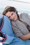 Woman relaxing in boat on still lake