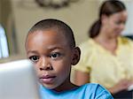 Boy using laptop in living room