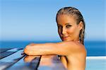 Woman relaxing on side of pool