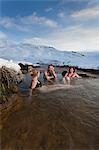 Friends relaxing in glacial hot spring