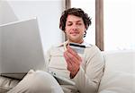 Man shopping online in living room