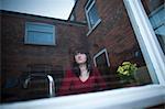 Disappointed woman standing in kitchen