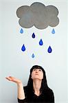 Woman standing under painted rain cloud