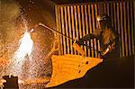 Welder at work in steel forge