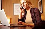 Businesswoman using laptop in hotel room