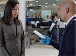 Security Guard Removing Prohibited Item from Woman's Bag at Airport