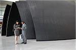 Business People Checking Boarding Passes in Airport