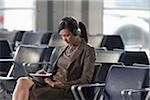 Businesswoman with Computer Tablet in Airport