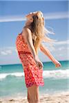 Woman Standing on Beach Feeling the Breeze