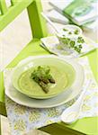 Cream of green asparagus soup with herbs