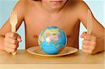 Child in front of a plate with a globe