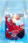 Summer fruit in a glass of water