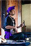 Man Playing Sanshin at Ryukyu Mura, Onna, Okinawa, Ryukyu Islands, Japan