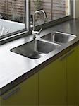 Stainless steel sink at uncurtained window of kitchen extension in Islington, London, UK, Paul Archer Design. Architects: Paul Archer Design