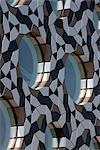 Ravensbourne, Greenwich, London. Round windows and Penrose pattern aluminium cladding. Architects: Foreign Office Architects